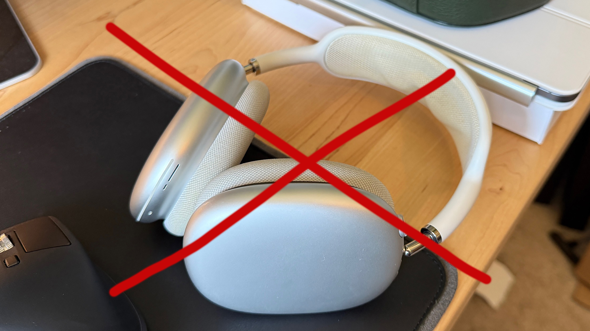 A photo of the AirPods Max with a red cross over them. 