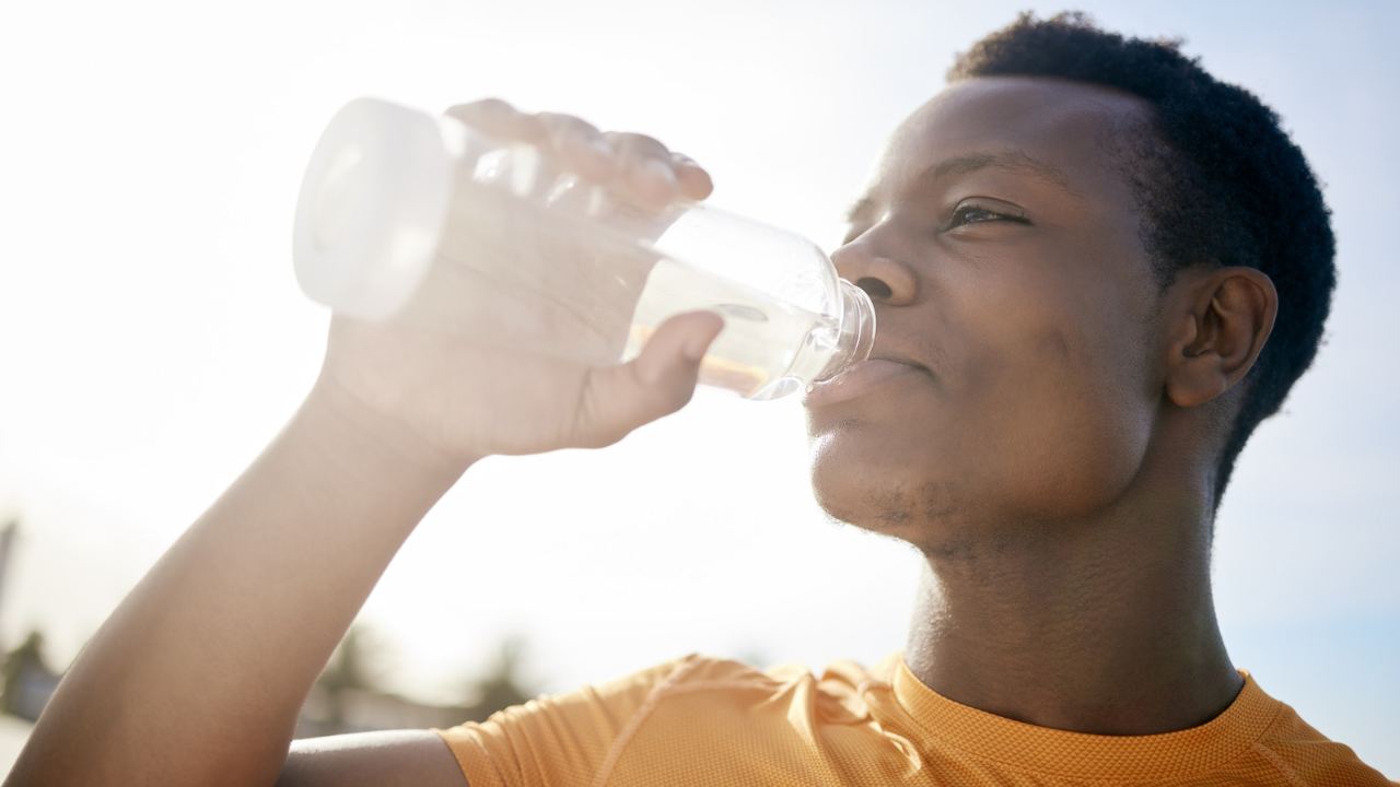 man drinking water from a bottle