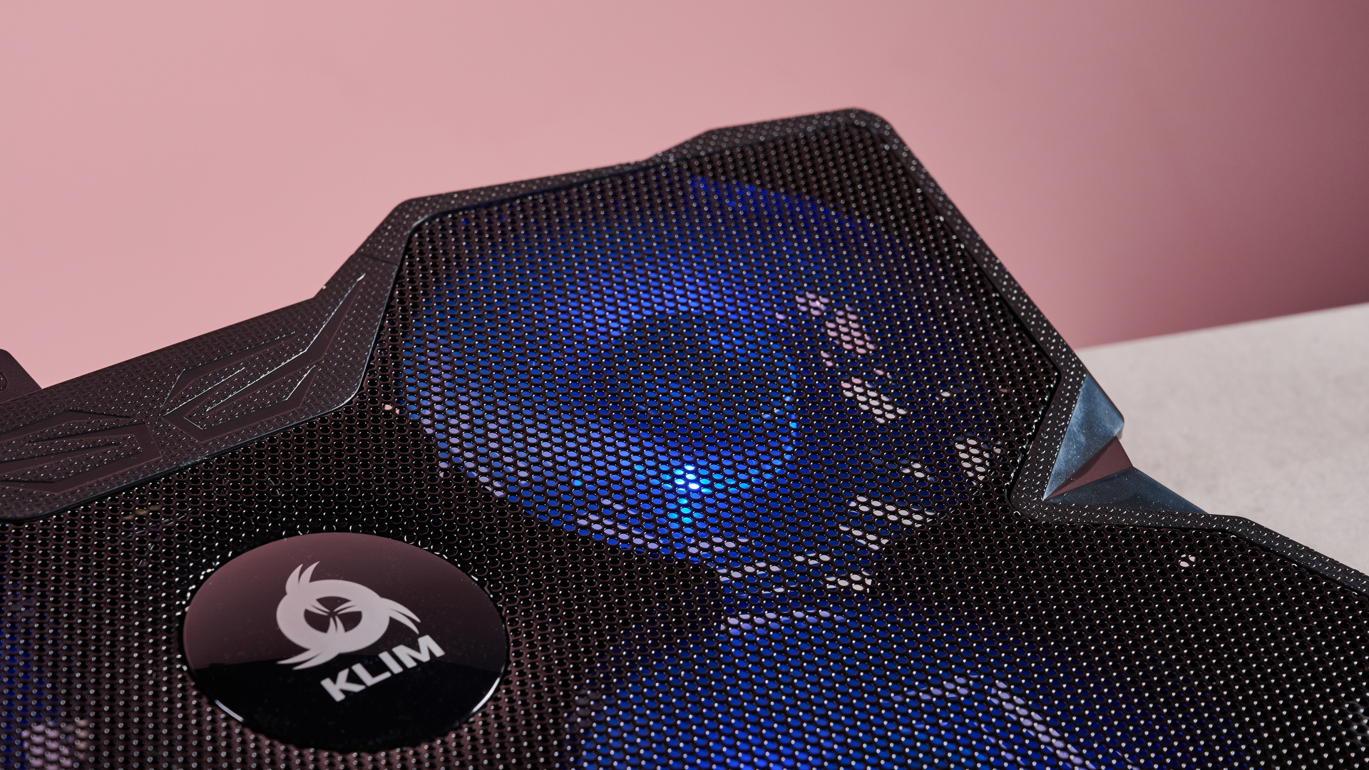 A closeup of the top right fan of the Klim Wind, spinning and lit up in blue.