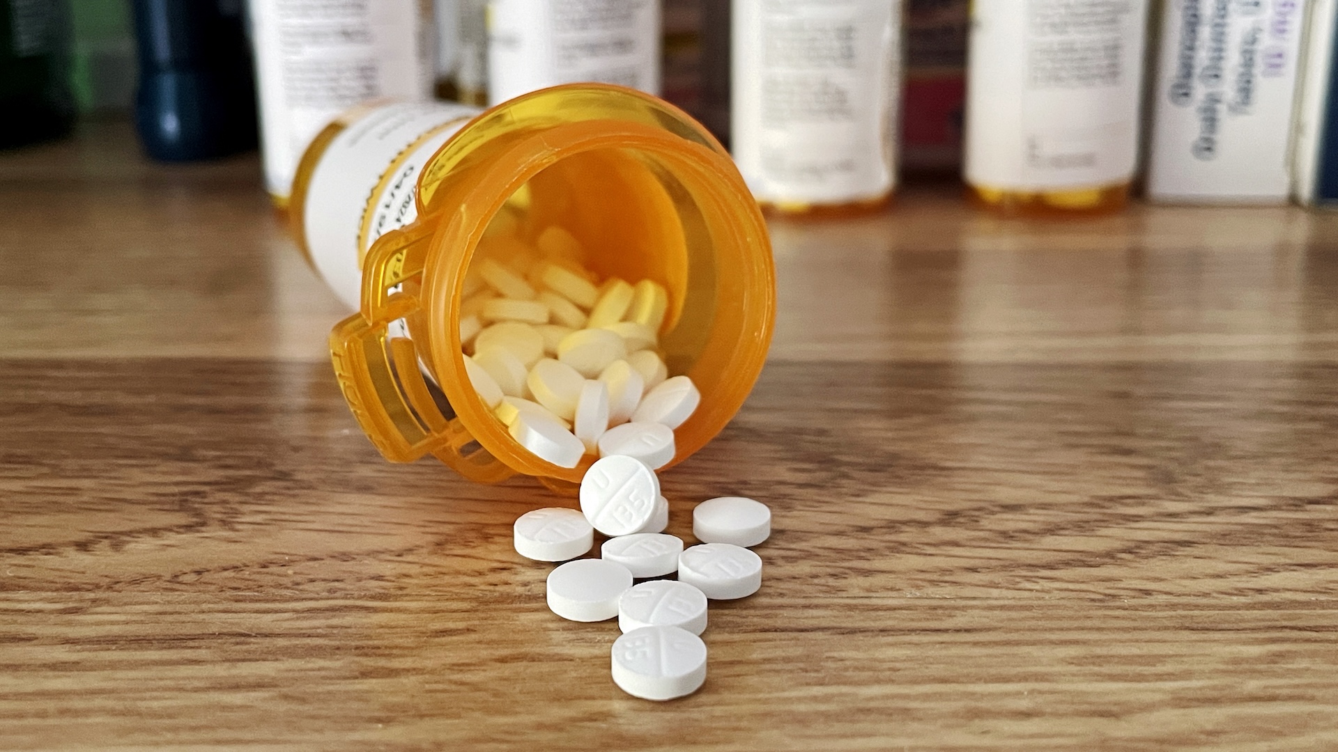 a bottle of antidepressant pills spilled out onto a table