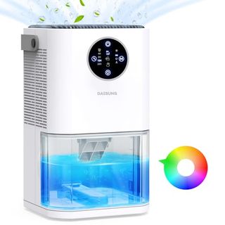 A small white dehumidifier with a large tank filled with blue liquid