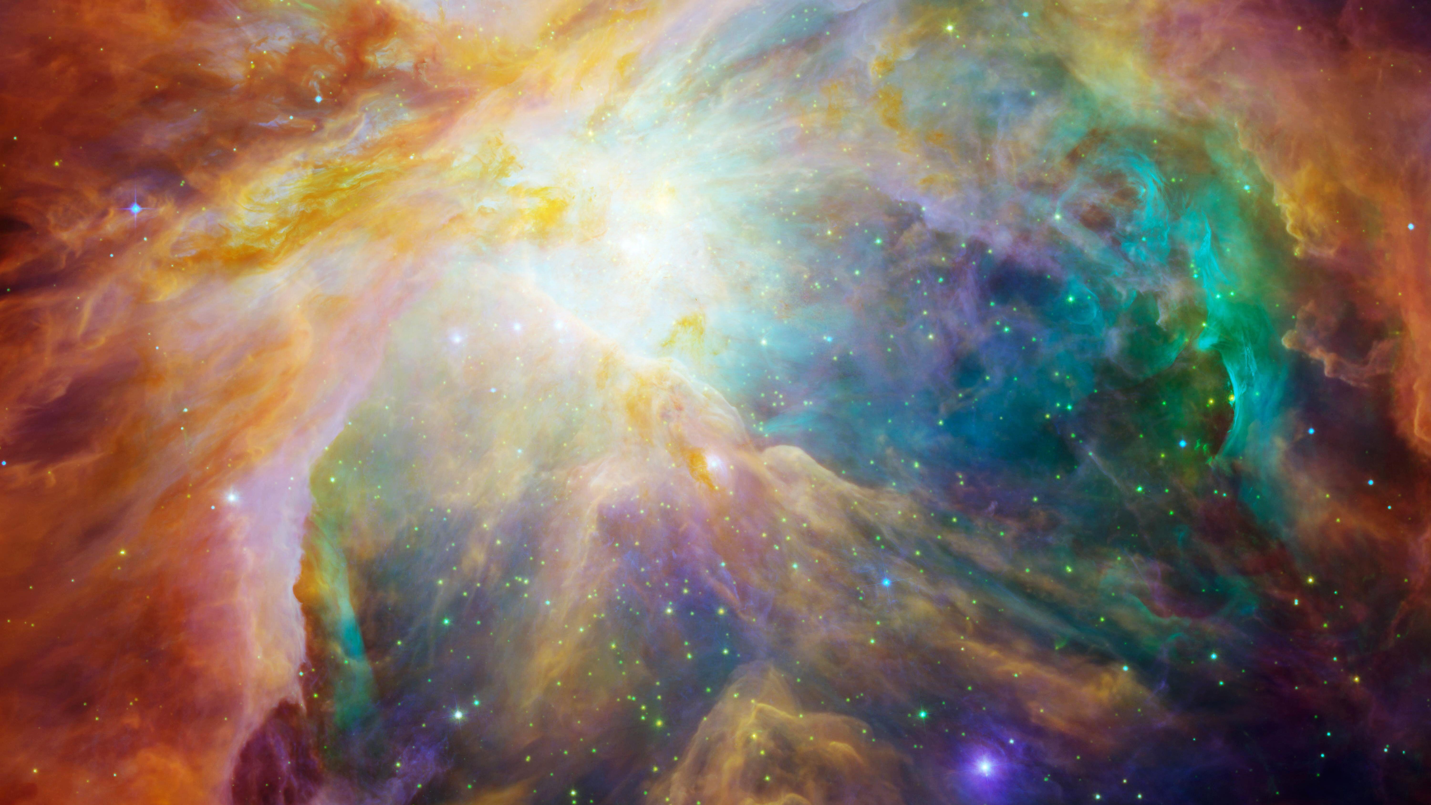 An image of the Orion Nebula showing a swirl of orange, green and purple..
