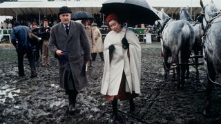 The Queen Walking Through The Mud To Present Prizes At The Windsor Horse Show.