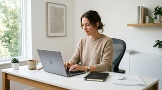 Woman at a desk using payroll software
