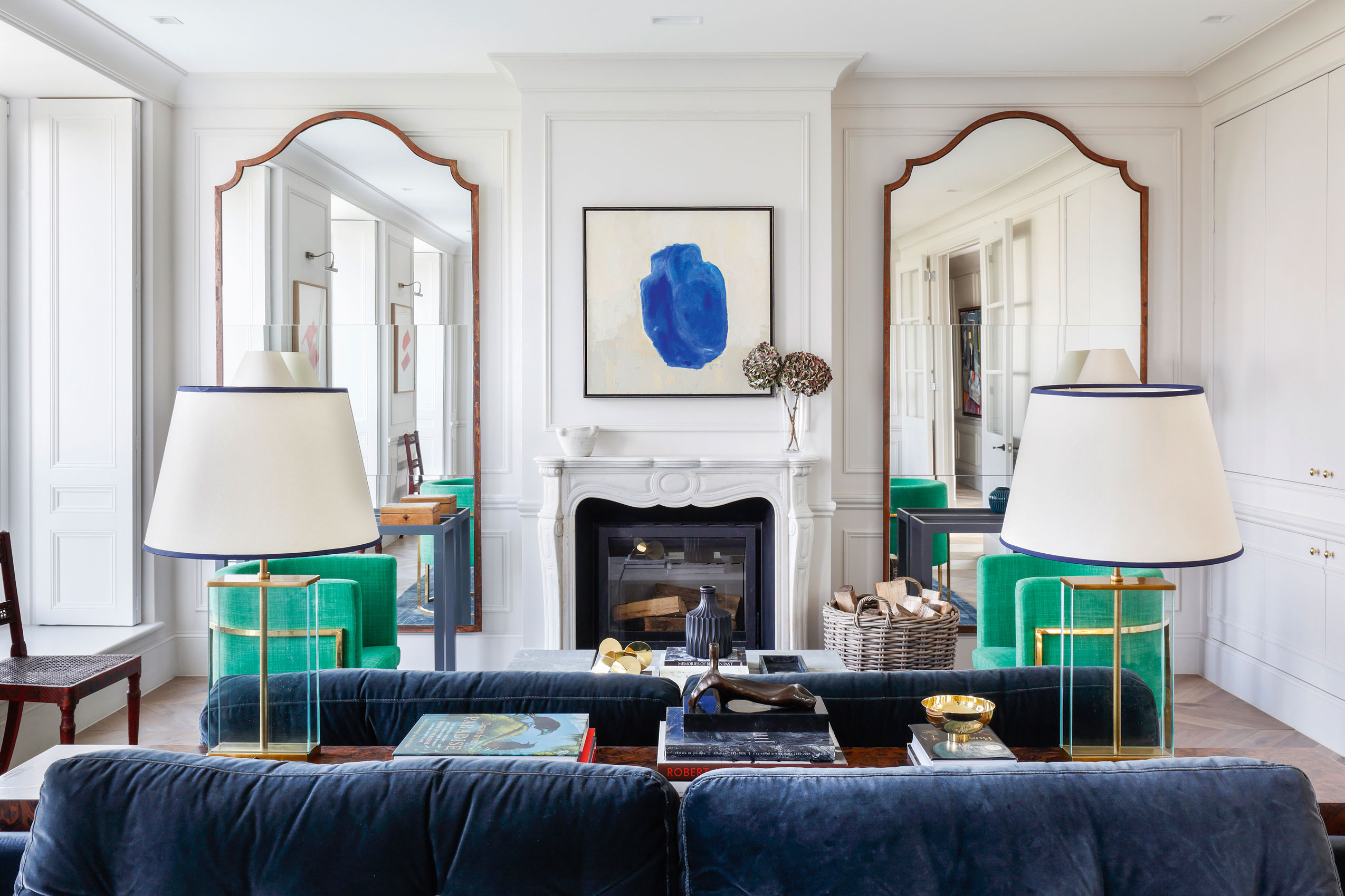 Living room with symmetrical mirrors and lamps