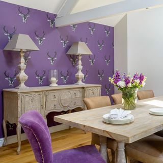 dining room with printed wall and wooden dining set