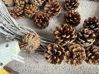 gluing pinecones to wreath