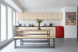 The kitchen at Sophie Dries' Paris loft, featuring an oak table and benches by Guillaume Gouerou