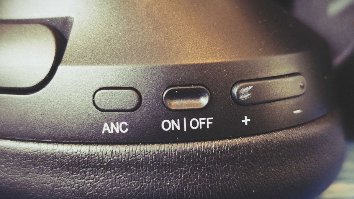 A pair of black OneOdio Focus A6 headphones on a gaming desk mat