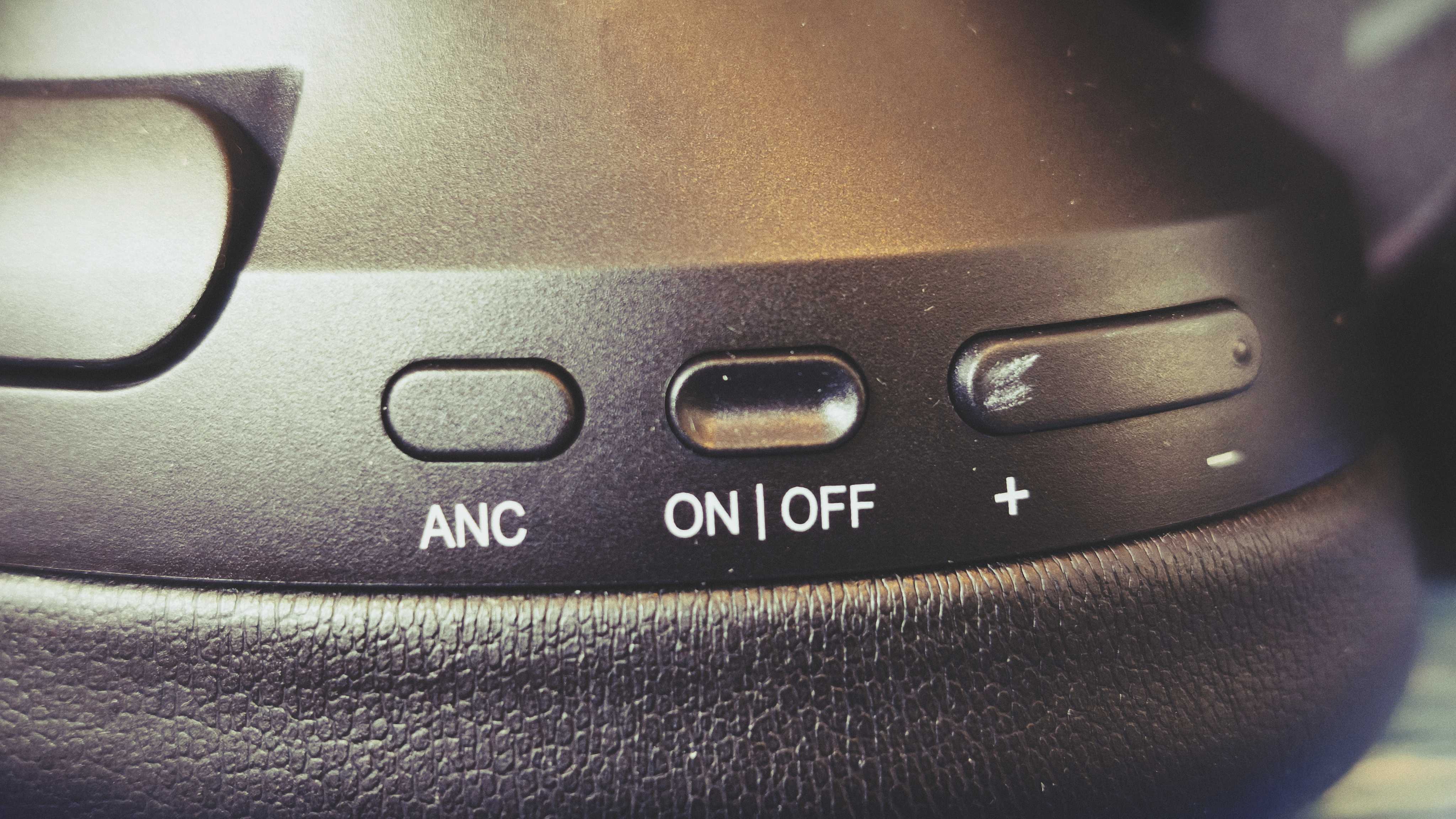 A pair of black OneOdio Focus A6 headphones on a gaming desk mat
