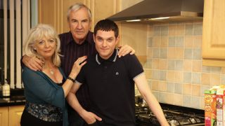Pam (Alison Steadman) and Mick (Larry Lamb) stand together in their kitchen with son Gavin (Mathew Horne) in Gavin & Stacey.