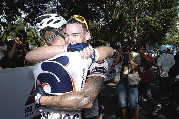 Stage winner Deon Locke is congratulated by Champion Systems teammate Holger Burkhardt in Haikou.