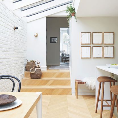 Open plan kitchen/dining space with steps leading up to a living area