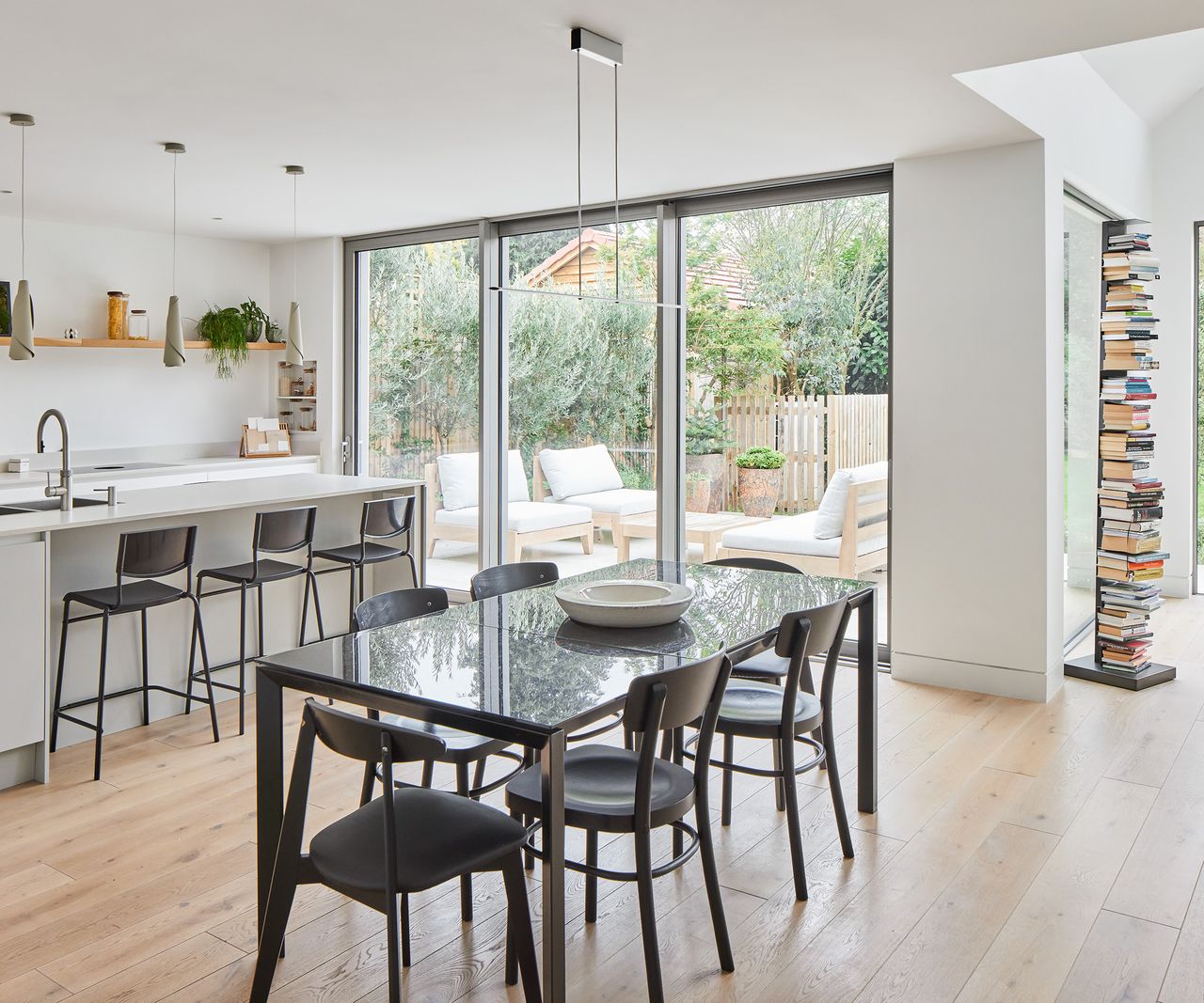 A dining table and and kitchen diner and a large glass sliding door
