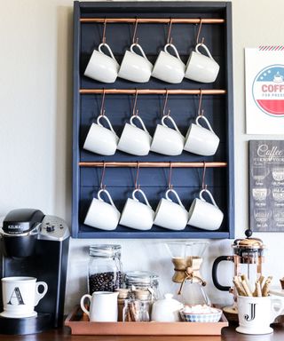 A navy wooden DIY coffee bar with copper bars