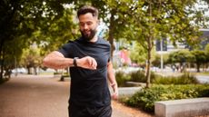 Male runner looking at his watch