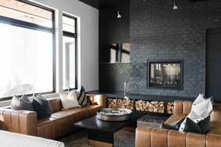 modern living room with tan leather sofas, fireplace and log storage