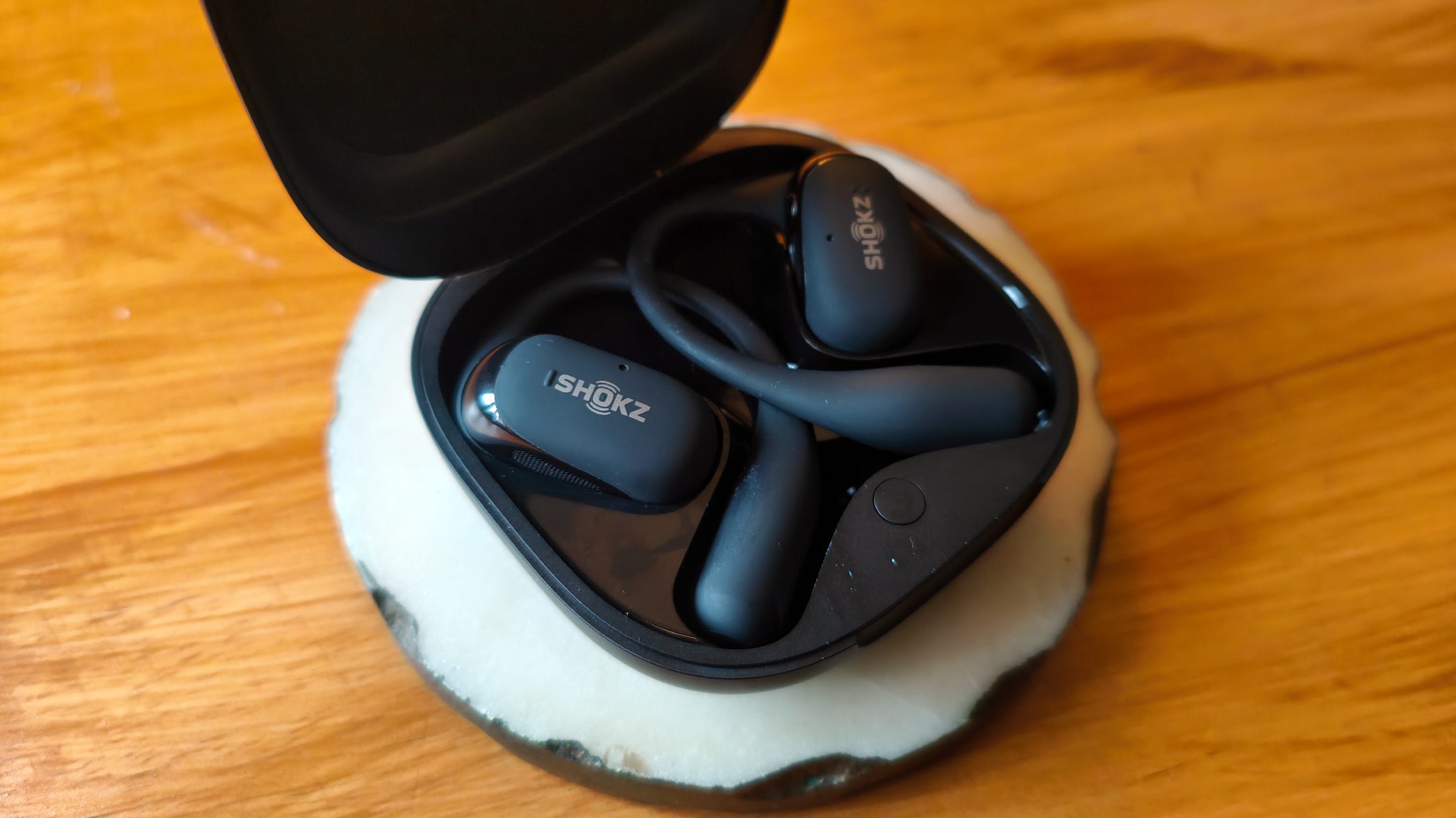Shokz OpenFit 2+ on wood