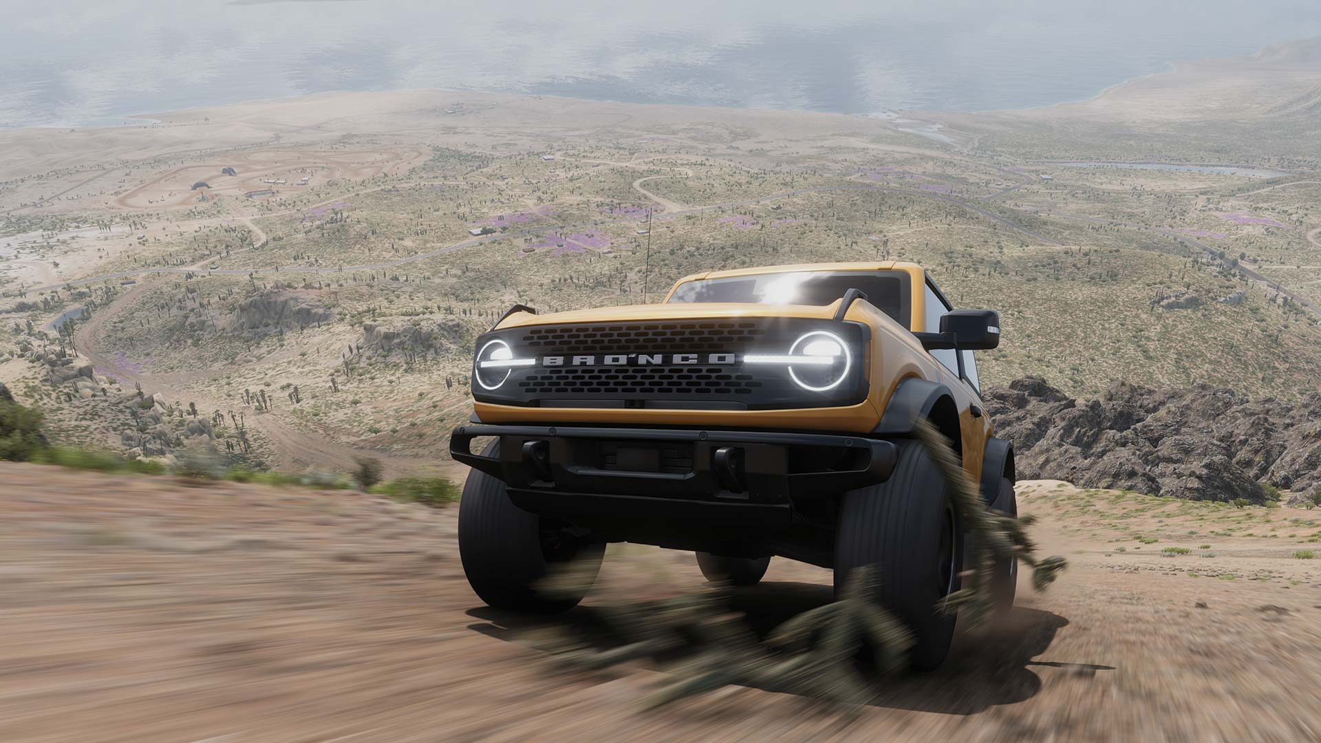 A screenshot from Forza Horizon 5 showing a Ford Bronco truck climbing a hill towards the camera