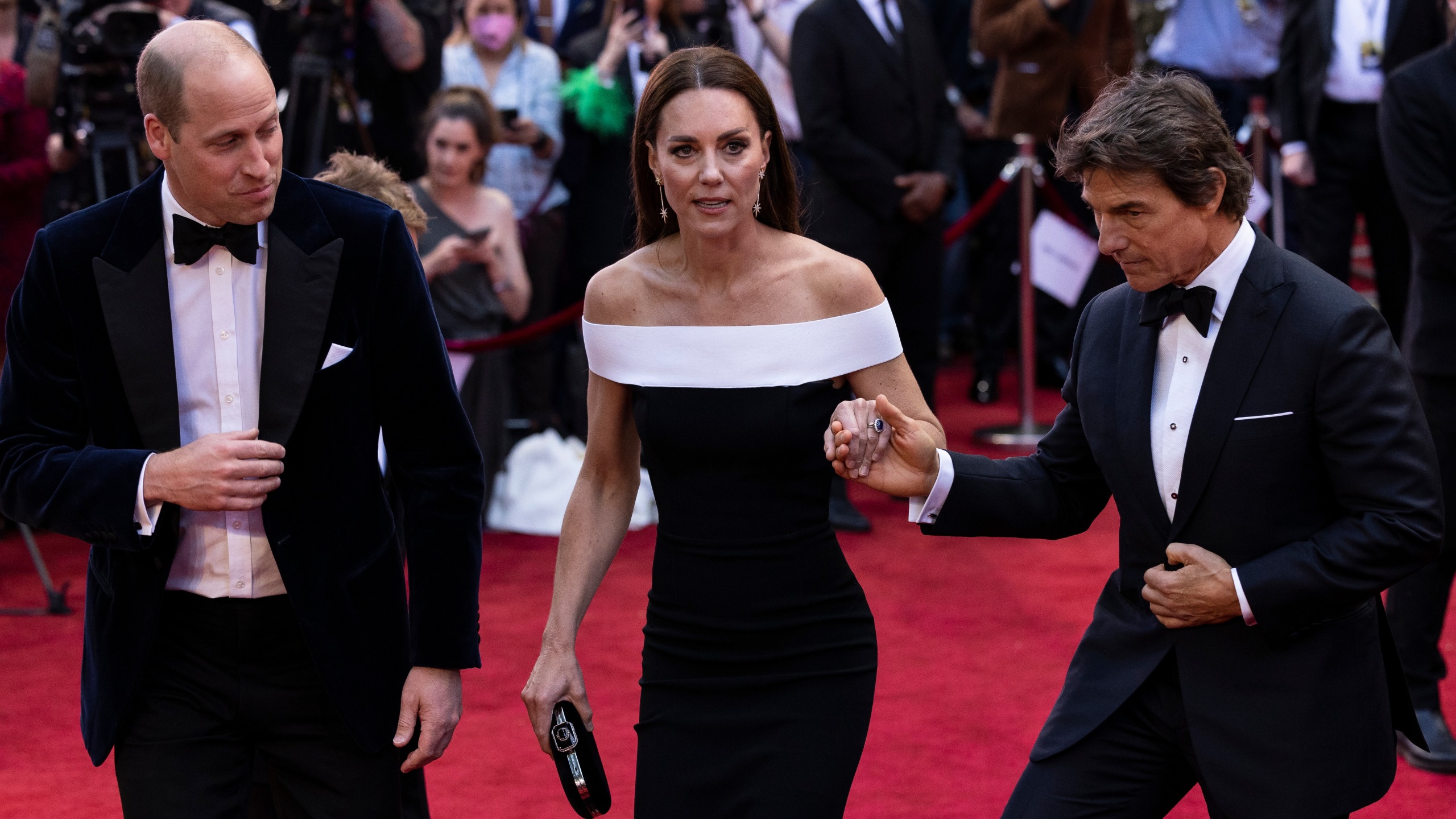 Prince William and Catherine, Princess of Wales are accompanied by star actor Tom Cruise as they arrive for the "Top Gun: Maverick" Royal Film Performance at Leicester Square on May 19, 2022
