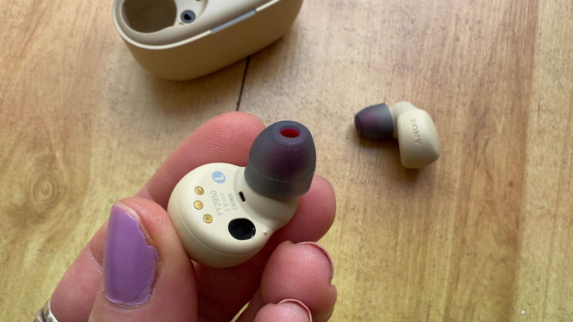 Reviewer holding one of the Sony Linkbuds S to show its design.