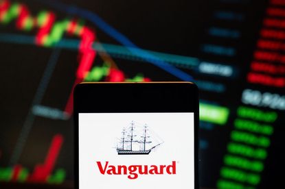 Vanguard logo seen displayed on a smartphone with a graph in the background