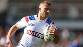 Mikey Lewis, wearing the white of England, carries the ball during the Rugby League World Cup 2026.