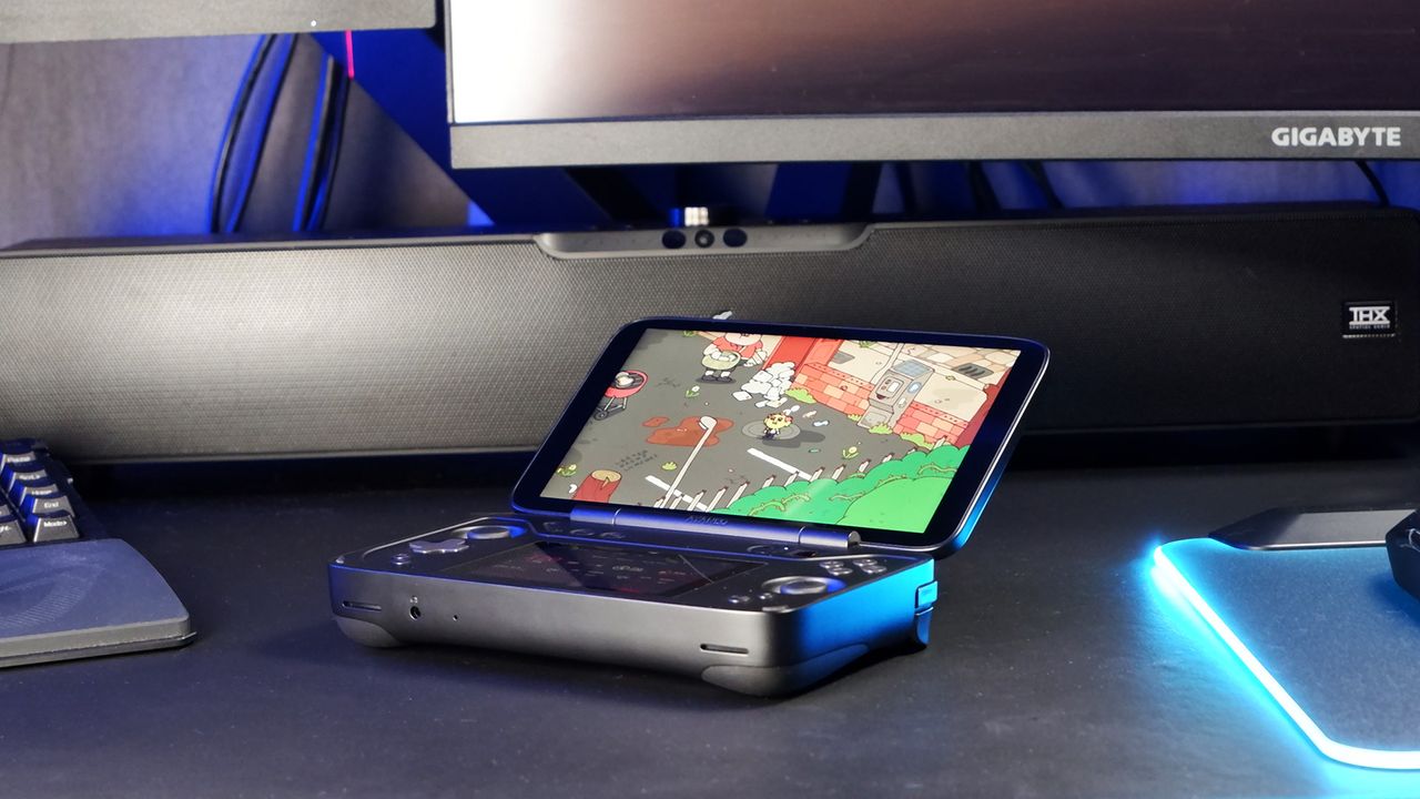 An Ayaneo Flip DS running a game while sat on a desk.