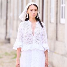 Model wears a floral appliqué top on the Skall Studio Spring Summer 2026 runway at Copenhagen Fashion Week.