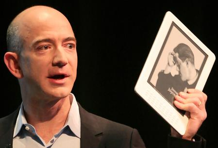 Jeff Bezos holding a Kindle