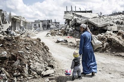A Syrian child and his mother in Kobane, Syria.