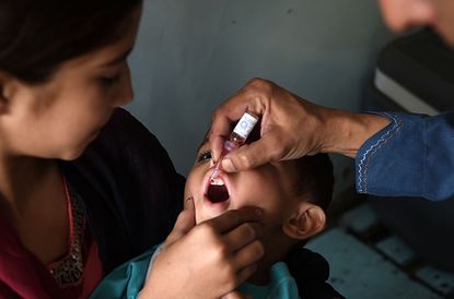A child in Pakistan receives a polio vaccine.