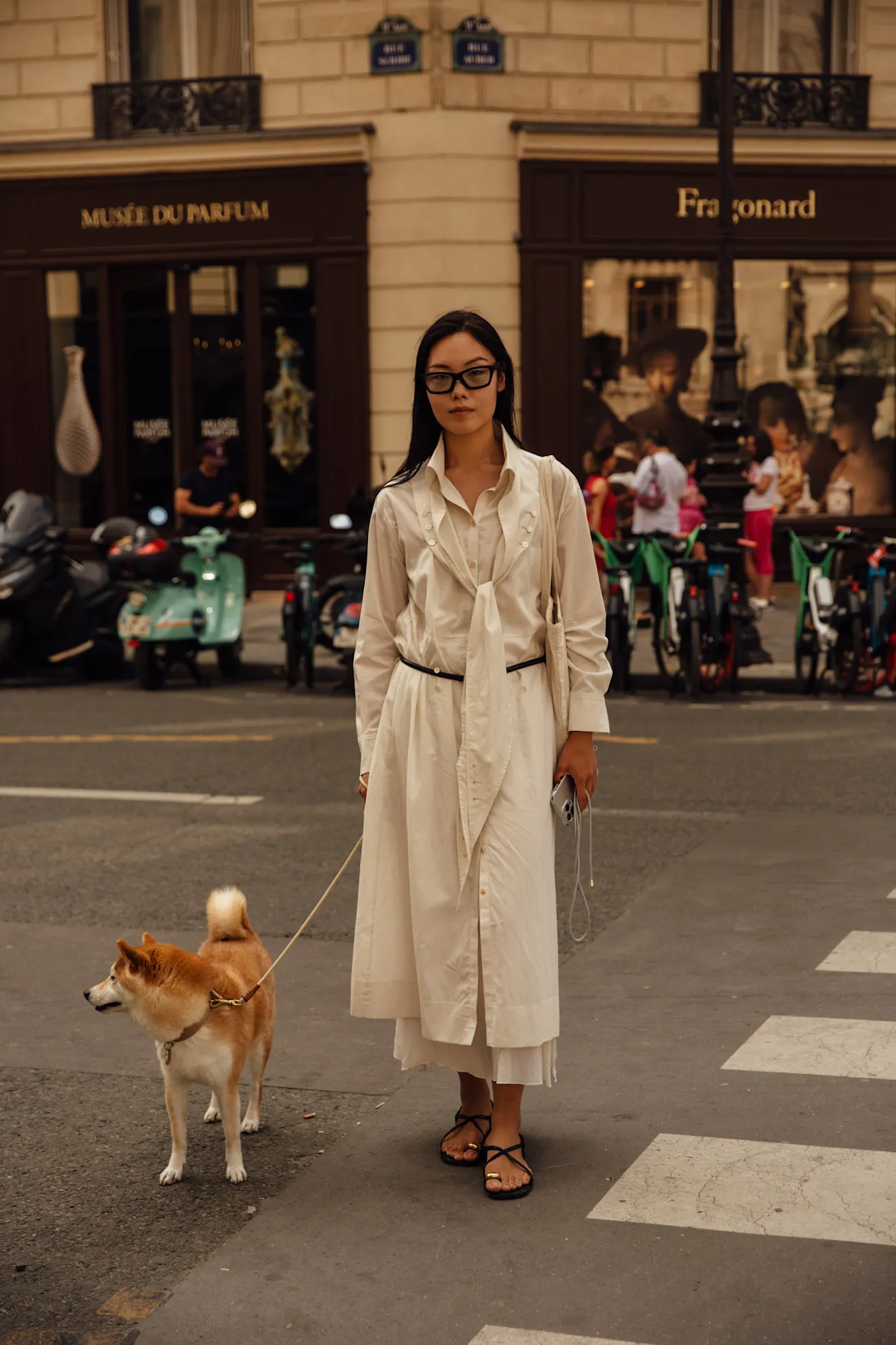 a guest at fashion week wearing an all white outfit with a toe ring sandal