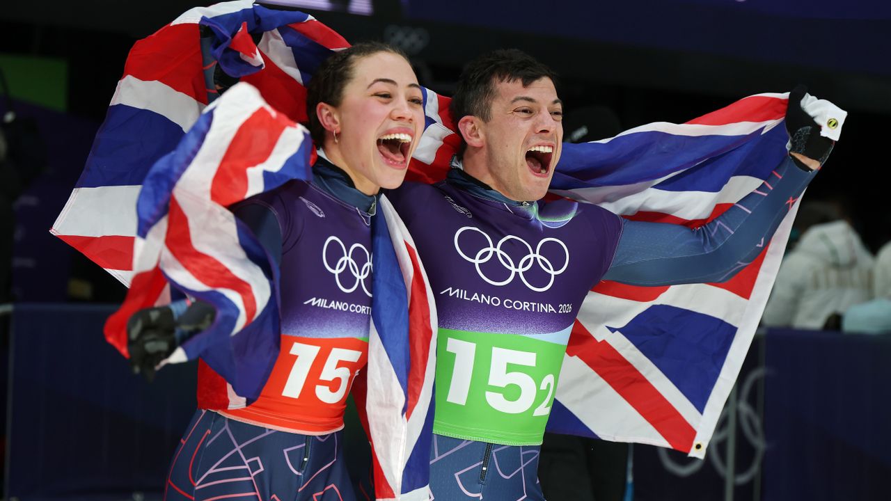  Tabitha Stoecker and Matt Weston of Team Great Britain celebrate winning the gold medals after competing in the Skeleton Mixed Team on day nine of the Milano Cortina 2026 Winter Olympic games at Cortina Sliding Centre on February 15, 2026 in Cortina d'Ampezzo, Italy. 