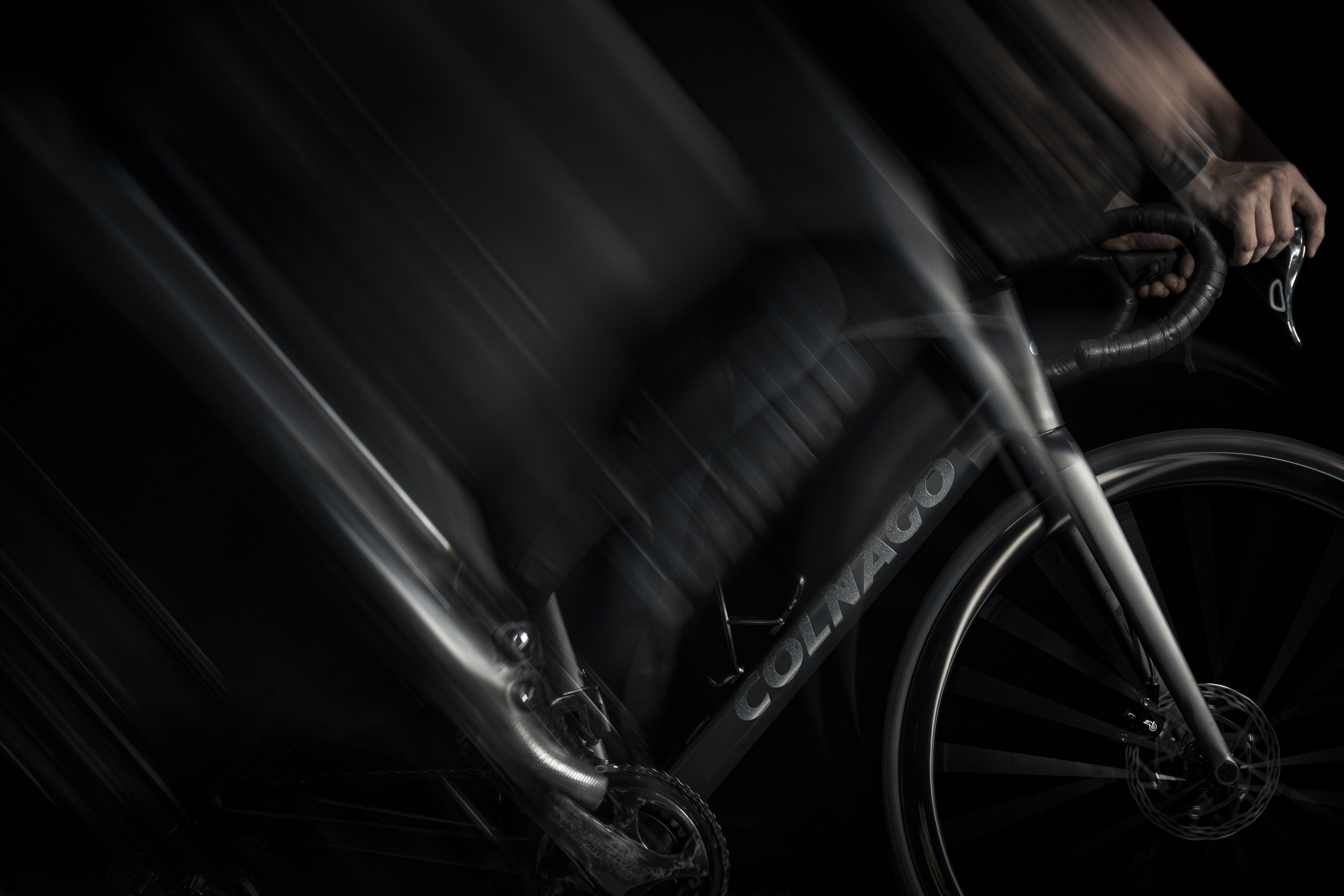 shadowy shots of a black Colnago bike on a black background