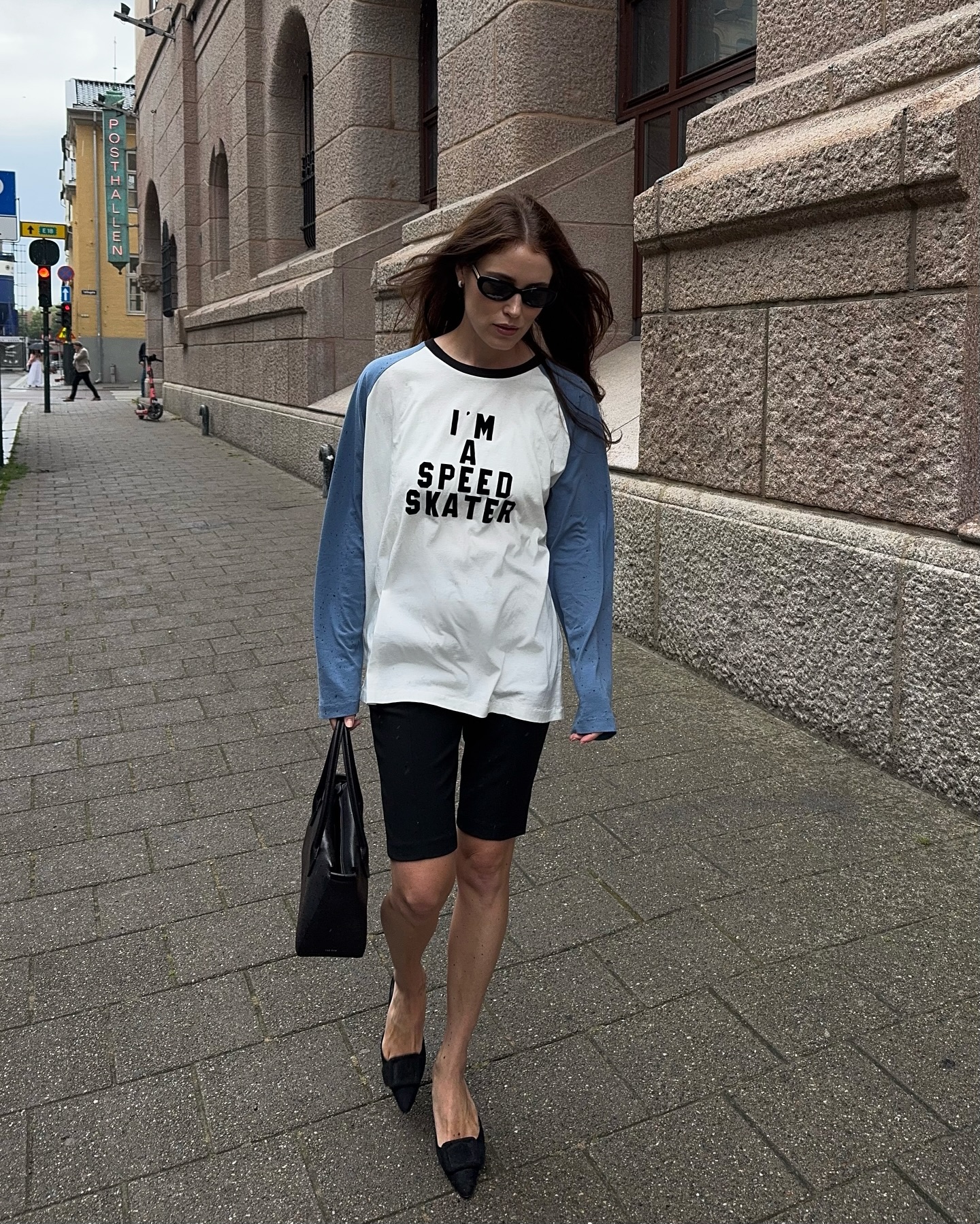 Norwegian influencer @annabelrosendahl wears a Bode baseball shirt with shorts and pointed-toe kitten heels.