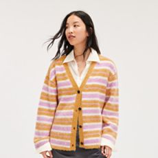 A person wearing a orange and pink striped cardigan from Monki