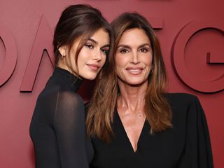 Kaia Gerber and Cindy Crawford pose for a photo together wearing black
