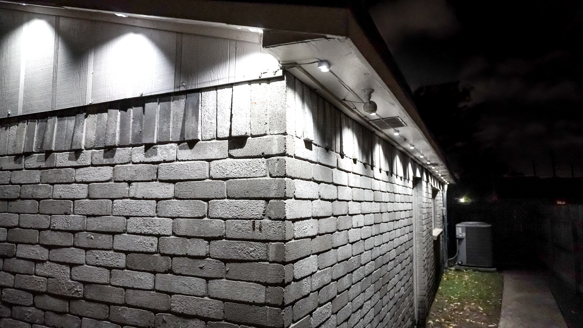 The backside of a house behind the garage lit with just Govee&#039;s Prism permanent outdoor lights