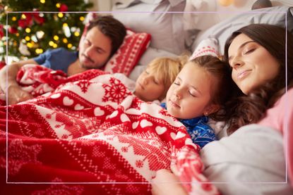 Family sleeping in a festive bed