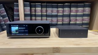 WiiM Ultra next to WiiM Pro Plus on wooden rack