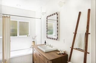 A neutral bathroom with a wooden vanity