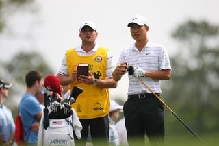 Anthony Kim takes the headcover of his fairway wood