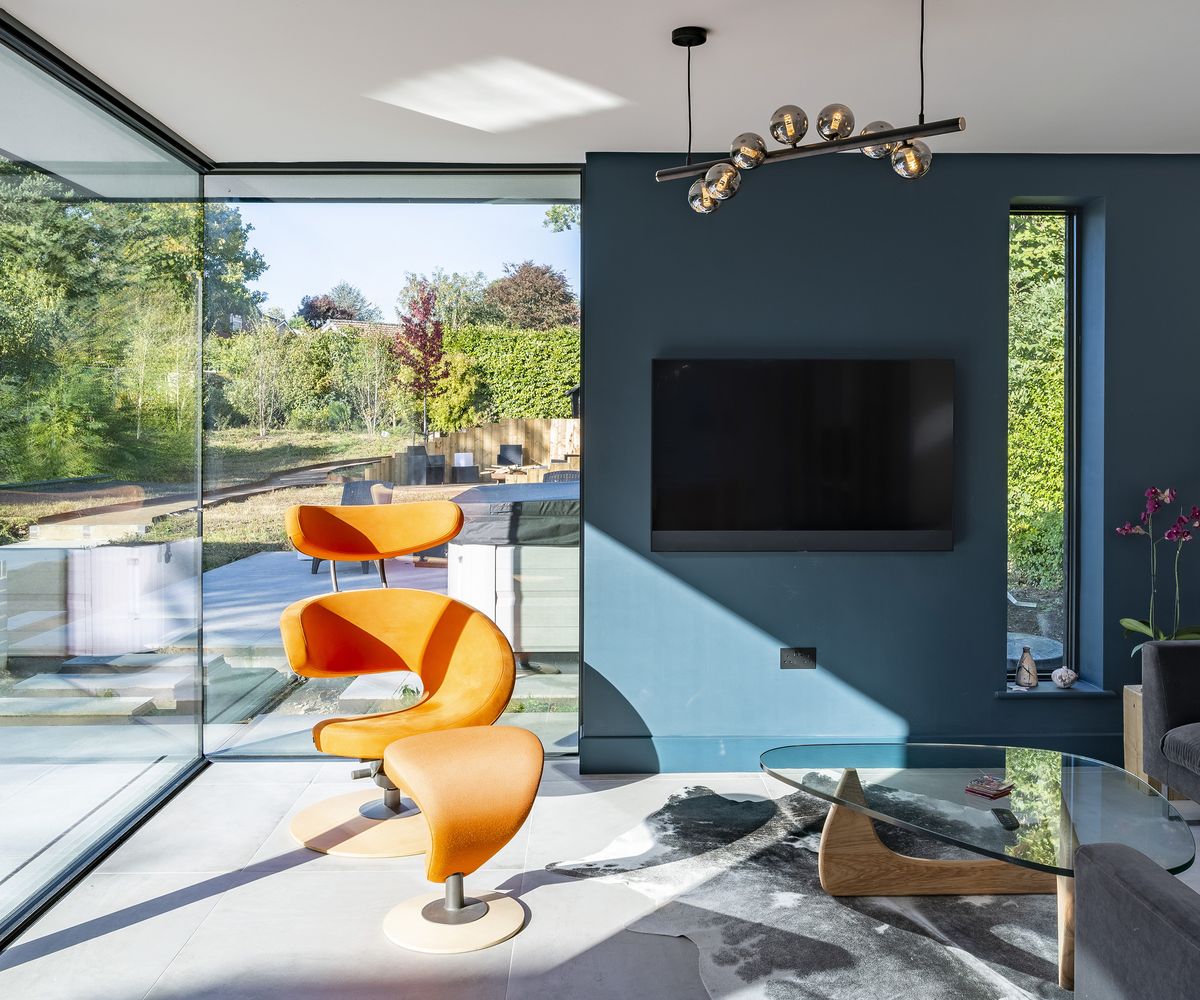 A glazed extension with lots of glass and natural light. There were peacock blue paint and orange furniture
