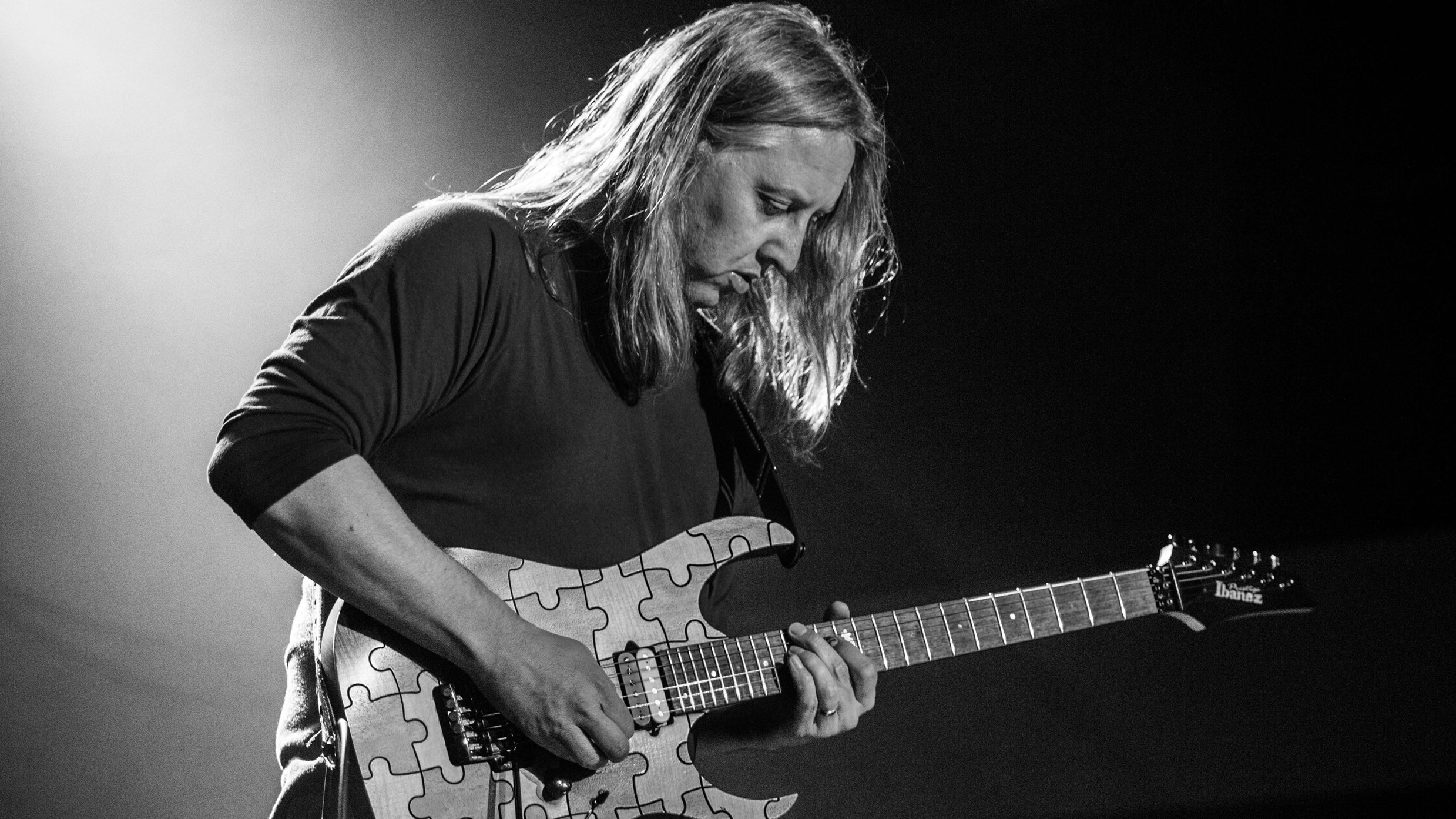 black and white portrait shot of Dave Foster with his guitar