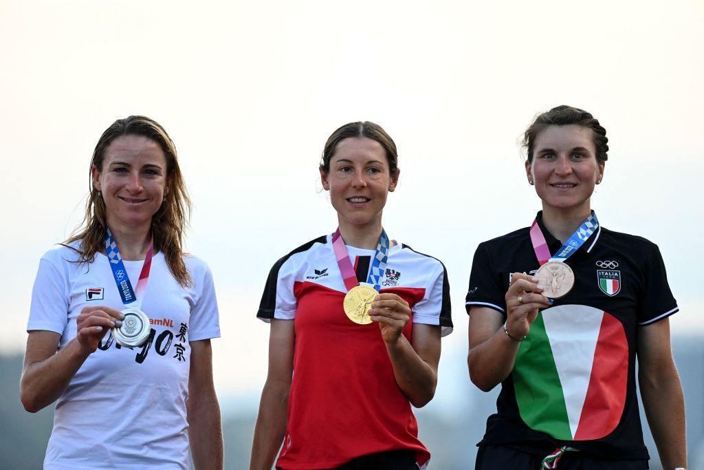 LR Silver medallist Netherlands Annemiek Van Vleuten Gold medallist Austrias Anna Kiesenhofer and bronze medallist Italys Elisa Longo Borghini pose for pictures on the podium during the medal ceremony for the womens cycling road race of the Tokyo 2020 Olympic Games at the Fuji International Speedway in Oyama Japan on July 25 2021 Photo by Greg Baker AFP Photo by GREG BAKERAFP via Getty Images