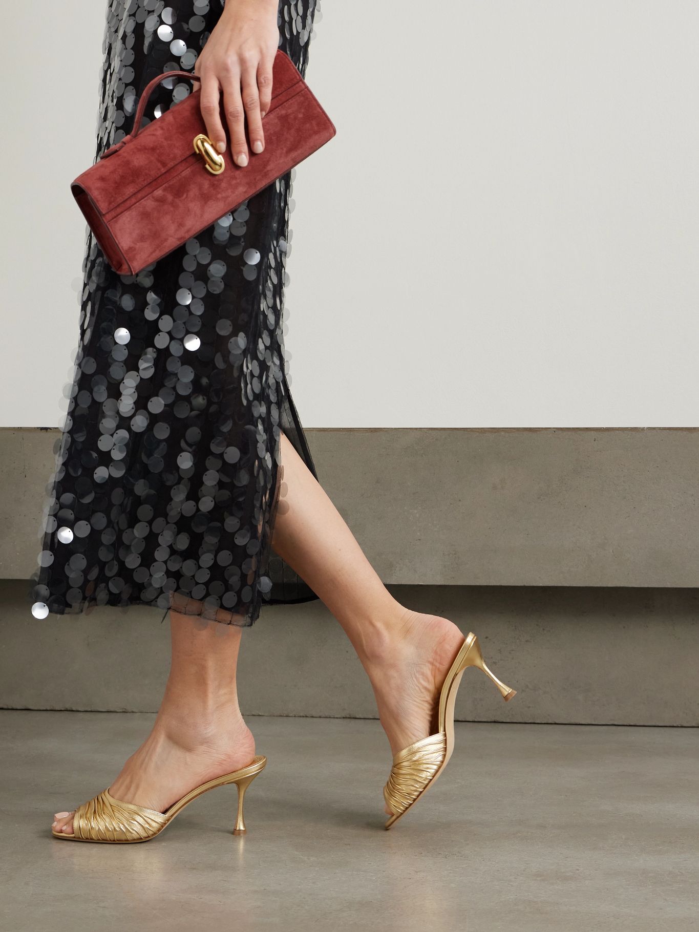a model wearing gold heels from manolo blahnik