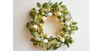 An Easter wreath with different types of feathers or spring flowers like daffodils