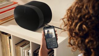 Sonos app in front of Sonos speakers