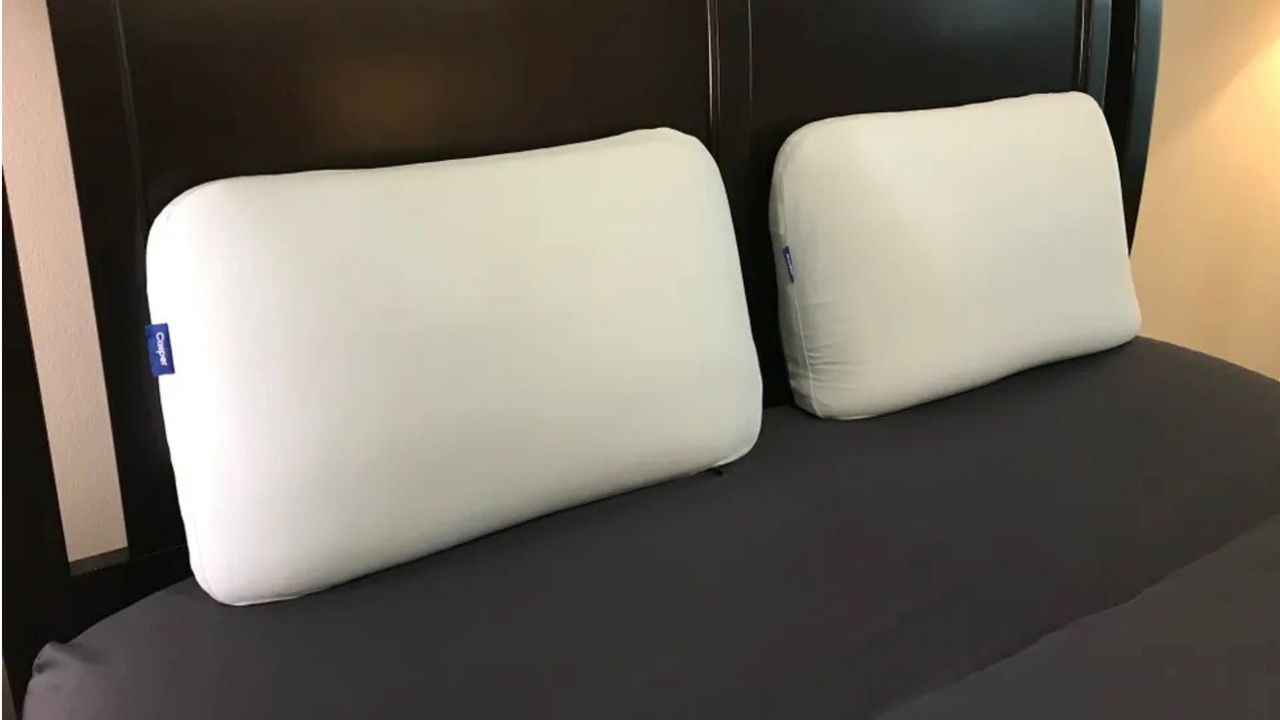 Two Casper Hybrid Snow Pillows resting against a headboard